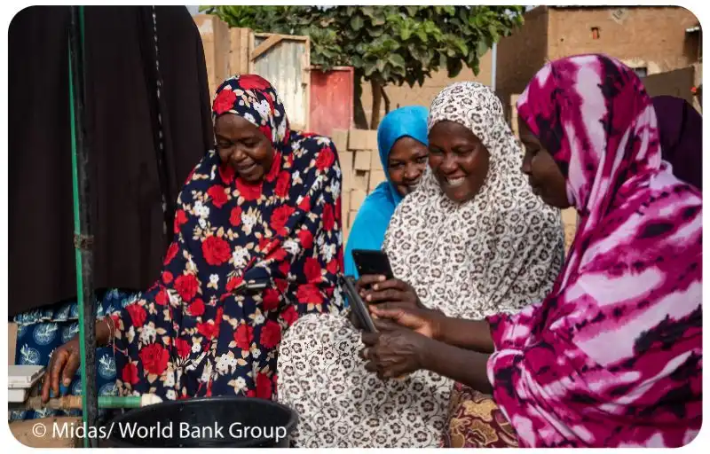 Group of ladies using mobile phone and showing each other how to use it